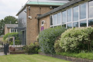 Photo of The Halley Academy building taken from a green space on the academy grounds.