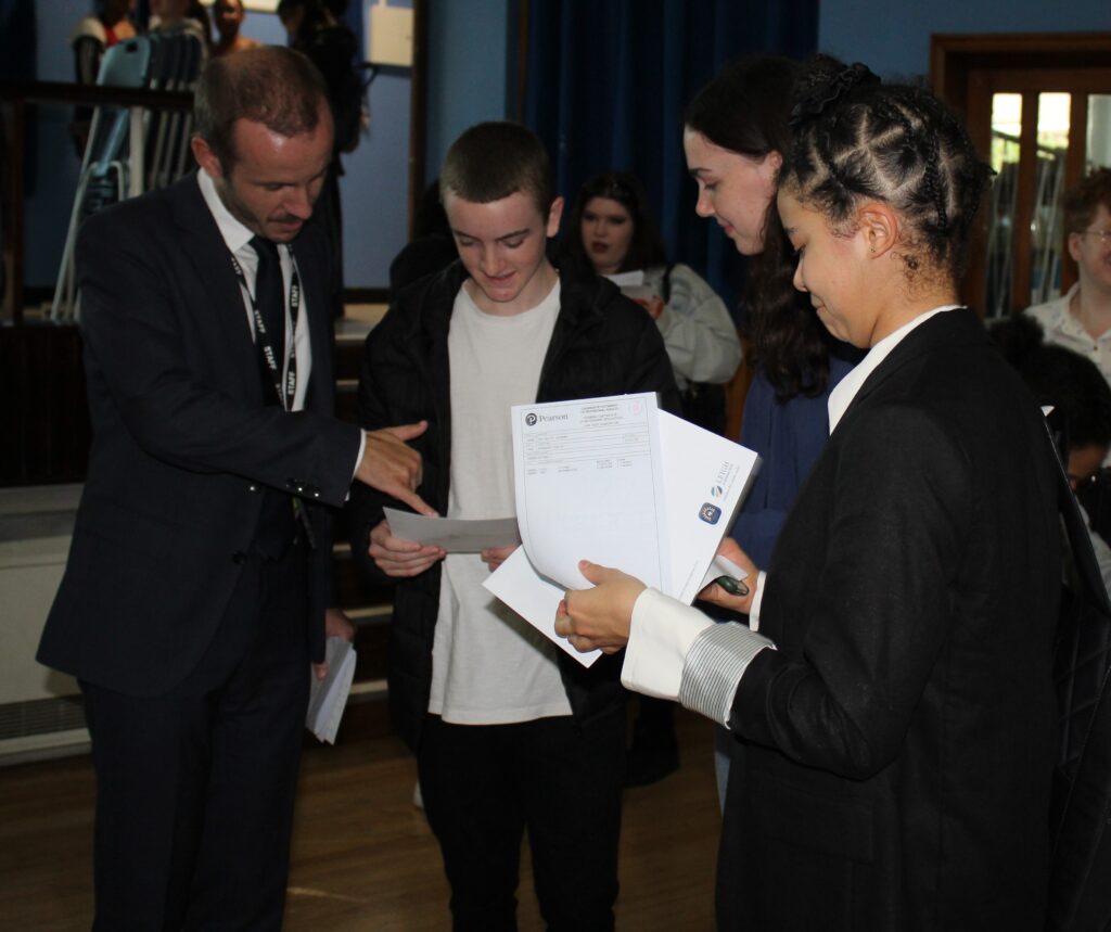 Students opening their results with Ben Russell, Principal