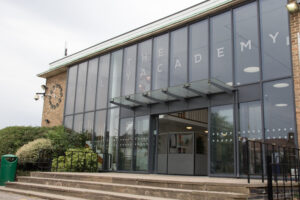 An exterior shot of one of the entrances to The Halley Academy building.